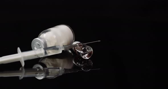 Syringe and Medicine on Black Background Isolated