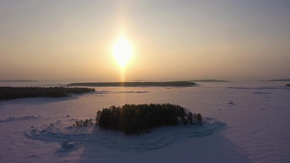 Frozen Kandalaksha Bay and Tree Islands on Winter Sunny Day