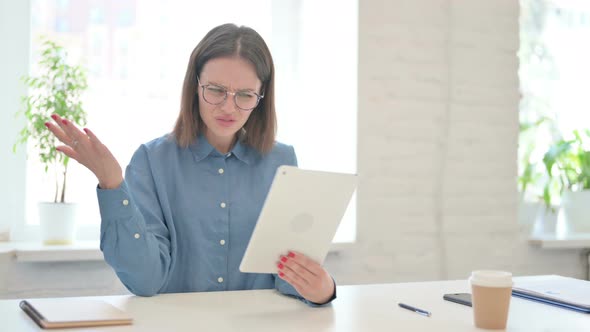 Young Woman Reacting to Loss on Tablet