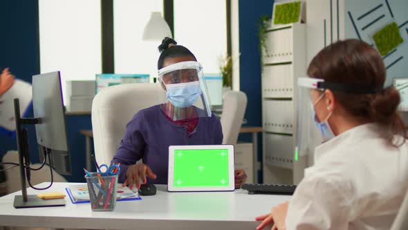 Black Woman Showing To Manager Tablet with Green Screen