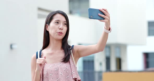 Woman taking selfie on cellphone in Shum Yip Upperhills of shenzhen