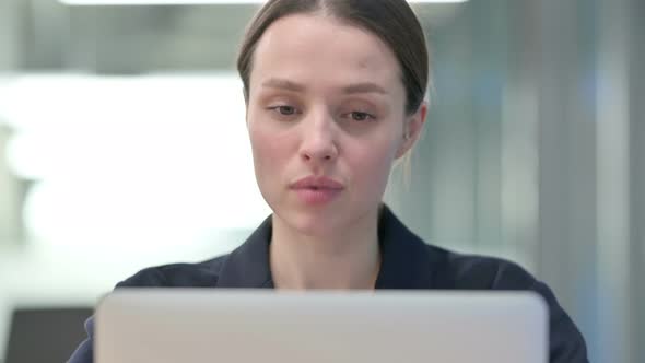 Portrait of Young Businesswoman Talking on Video Call on Laptop