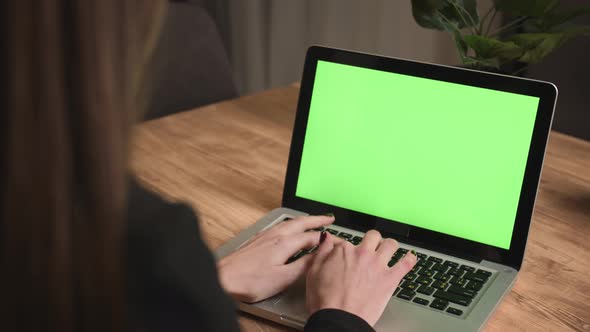 Caucasian businesswoman working on laptop green screen chromakey at home office