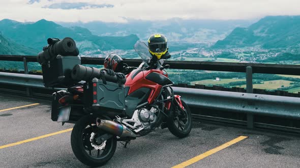 Motorbike with Luggage Bags Stands By Mountain Landscape of Alps Liechtenstein