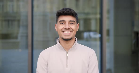 Young happy indian man portrait smiling and looking at camera