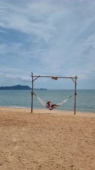 Women Relaxing in a Hammock on the Beach in Pattaya in Thailand Ban Amphur Beach