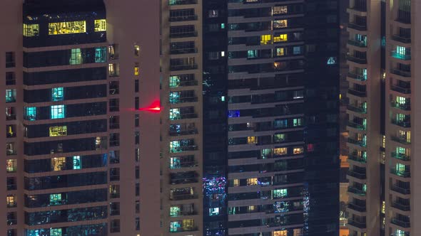 Windows in Highrise Building Exterior in the Late Evening with Interior Lights on Timelapse