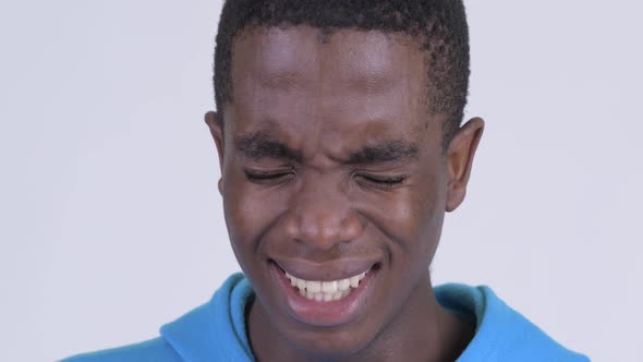 Face of Young Sad African Man Looking Depressed and Crying
