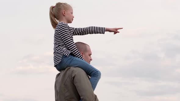 Young Dad Gaily Spending Time with Daughter Playing Together Outdoors on Summer