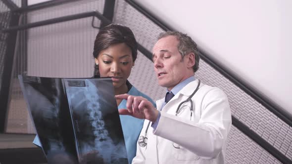 CU Doctor holding xray and discussing with nurse in hospital / London, United Kingdom