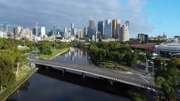 Drone shot of Melbourne in COVID lockdown during the day. Sweeping city skyline with an empty bridge