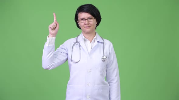 Beautiful Woman Doctor with Short Hair Pointing Up