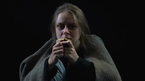 Poor Woman Covered in Dirty Blanket Crying Eating Crust of Bread, Poverty, War