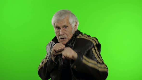 Elderly Caucasian Grandfather Rocker Man Shows Fist Fight. Chroma Key Background