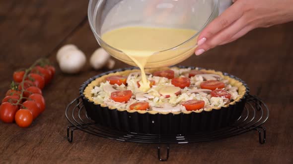 Step by step woman making Quiche Lorraine with chicken, mushrooms and cheese.French cuisine.