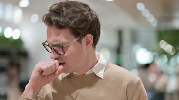 Sick Young Male Designer Coughing