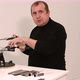 Man Shows a Master Class on Sharpening a Knife on a Machine - VideoHive Item for Sale