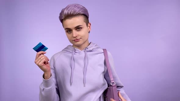 Young Adult Woman Holding Showing Condom Putting in Handbag Isolated