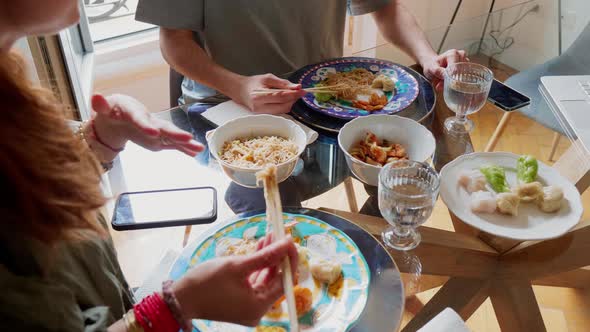 Couple eating Asian food at home