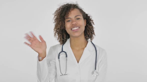 Welcoming African Female Doctor Waving Hand on White Background