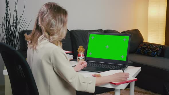 Woman at Laptop with Green Screen for Copy Space. Chromakey Mockup.