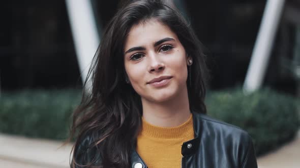 Face Portrait of Attractive Woman Standing on the Modern Street. Woman Smiling. Black Leather Jacket