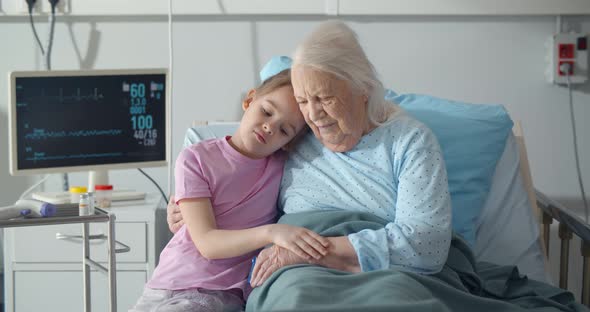 Upset Little Girl Visiting Her Grandmother at Hospital Ward