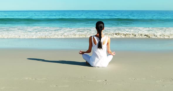 Rear view of woman performing yoga