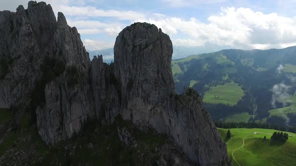 Aerial drone view of a man rock climbing up a mountain.