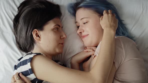 Top view video of lesbian couple together in bed. Shot with RED helium camera in 8K.