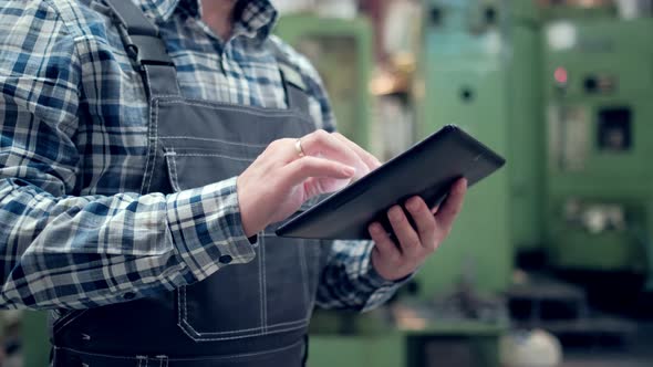 Engineer Is Using Tablet Pc In Factory