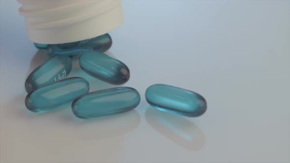 Slow motion of Prescription drugs - Capsules, pills, tablets falling on reflective background