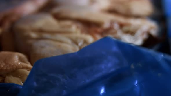 Macro View of a Box Full of Frozen Chicken Legs