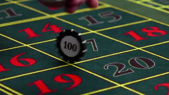 Croupier Twisting One Chip on Table at Casino, Slow Motion