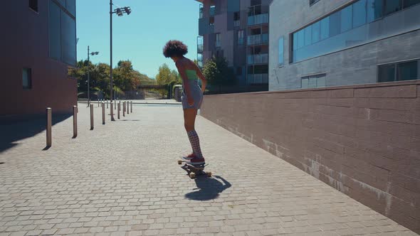 Beautiful young woman cruising around the city with her longboard.