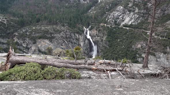 Approaching Sentinel Falls in Yosemite National Park California from cliff with fallen tree, Aerial