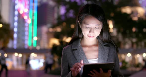 Young business woman use of tablet computer at night