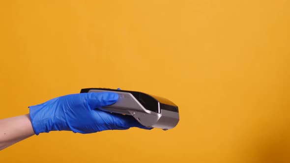 Person in a Blue Rubber Medical Glove Pays