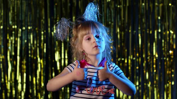 Teen Cute Girl Showing Thumbs Up Approval Success Gesture at Disco Party Club in Blue Neon Lights