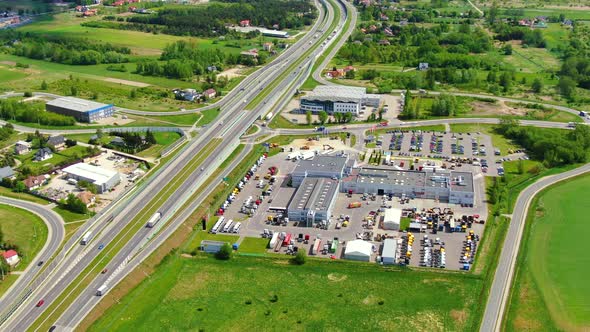 Buildings of logistics center, warehouses near the highway, view from height, a large number of truc