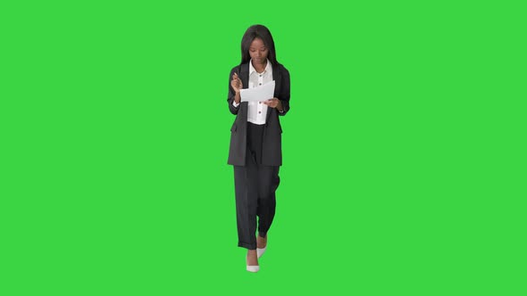 Serious African American Woman Reading Documents While Walking Green Screen Chroma Key