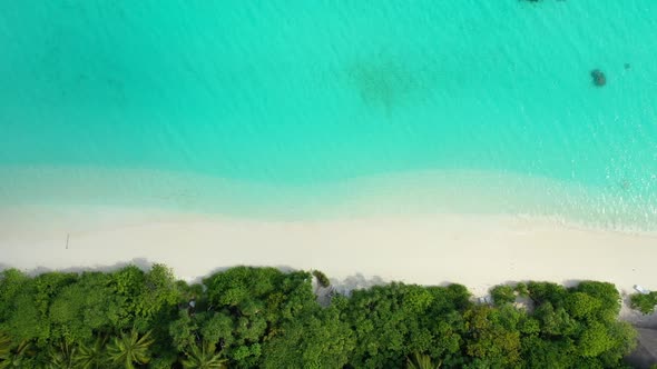 Aerial drone texture of idyllic resort beach holiday by clear sea with white sandy background of a d