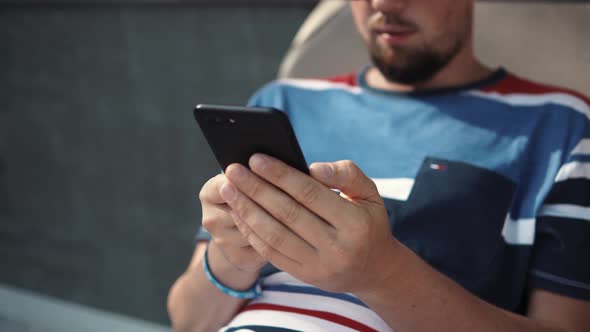 Adult Man Lying with Smartphone.