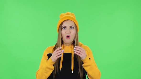 Portrait of Modern Upset Girl in Yellow Hat with Shocked Wow Face Expression. Green Screen