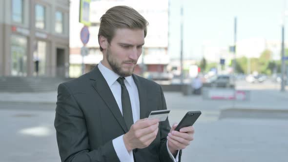 Excited Businessman Shopping Online Via Smartphone Outdoor