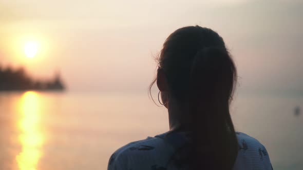 Silhouette of the Woman Walking at the Beach During Beautiful Sunset