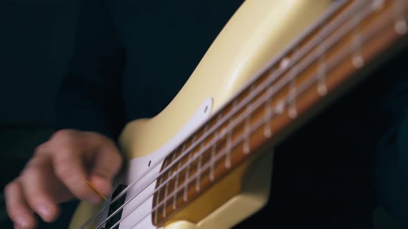 Professional Music Teacher Plays Solo on White Bass Guitar