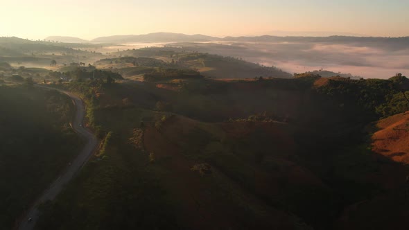 4K Scenic flight over beautiful mountain scape with bright sky and clouds