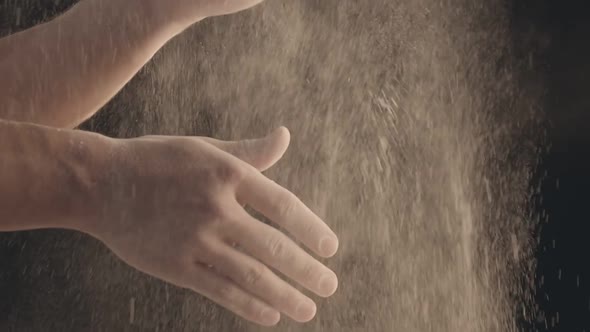 Closeup of Male Hands Shaking Off Flour