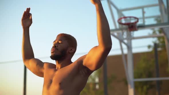 Slow Motion in Early Morning Young African American Man with Naked Body Putting Hands Up and